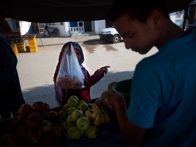 A vendor sells fruit at the Sidi Bouzid market where fruit-seller Mohammed Bouazizi worked. Bouazizi's self-immolation in front of the governor's offices nearby was the catalyst for protests all over the county.