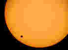 The planet Venus is seen crossing the sun in June 2004 as photographed through a telescope at Planetarium Urania in Hove, Belgium. The earliest known observation of such a transit was in 1639 by English astronomer Jeremiah Horrocks.