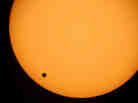 The planet Venus is seen crossing the sun in June 2004 as photographed through a telescope at Planetarium Urania in Hove, Belgium. The earliest known observation of such a transit was in 1639 by English astronomer Jeremiah Horrocks.