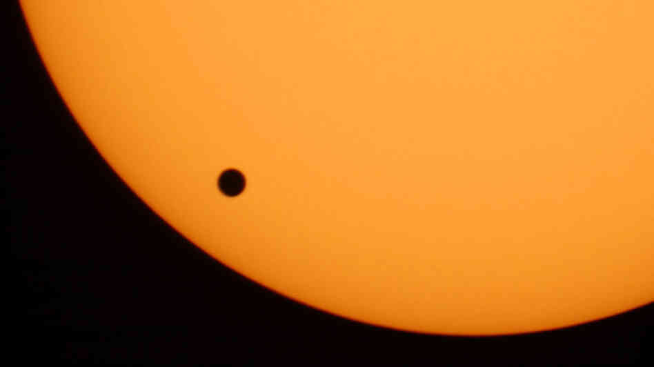 The planet Venus is seen crossing the sun in June 2004 as photographed through a telescope at Planetarium Urania in Hove, Belgium. The earliest known observation of such a transit was in 1639 by English astronomer Jeremiah Horrocks.