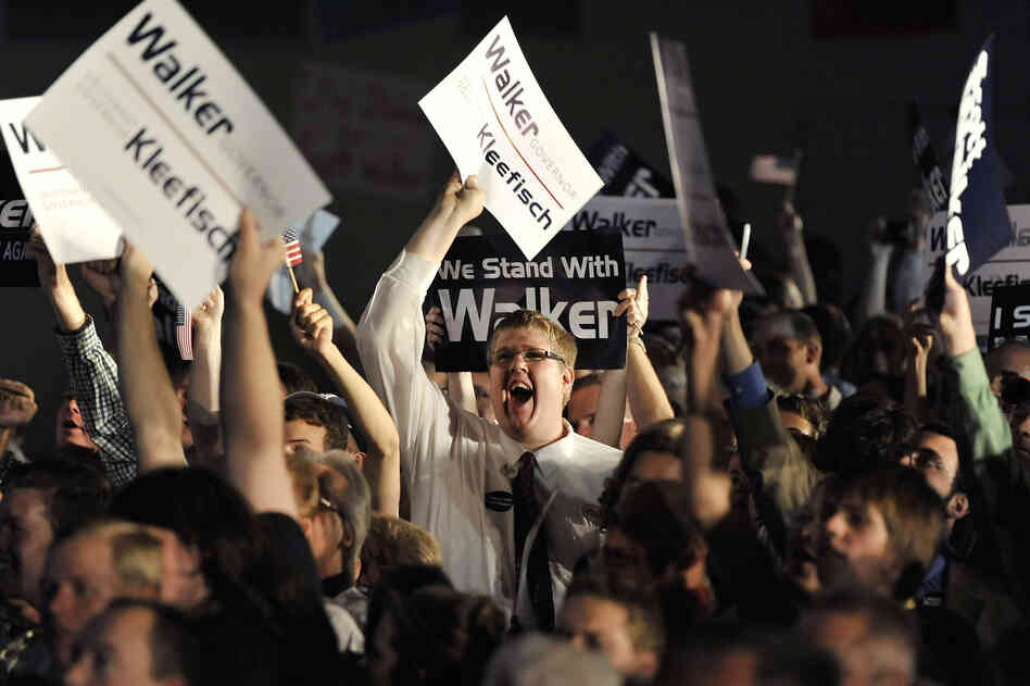 Walker supporters watch returns as they await the governor's speech at an election night rally on Tuesday in Waukesha.