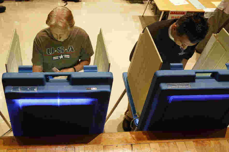 Voters cast ballots in Milwaukee. Critics of the governor gathered more than 900,000 signatures in support of the recall.