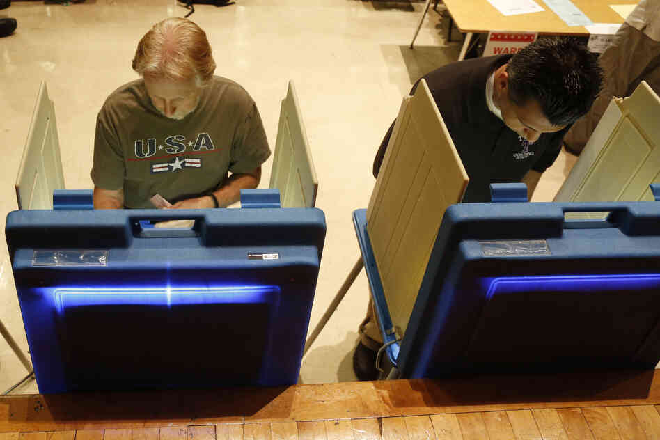 Voters cast ballots in Milwaukee. Critics of the governor gathered more than 900,000 signatures in support of the recall.