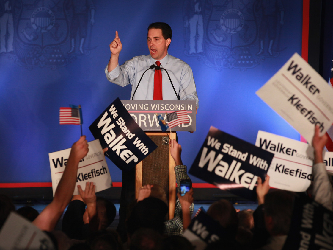 Wisconsin Gov. Scott Walker greets supporters at a rally Tuesday in Waukesha, Wis., after weathering a recall challenge.