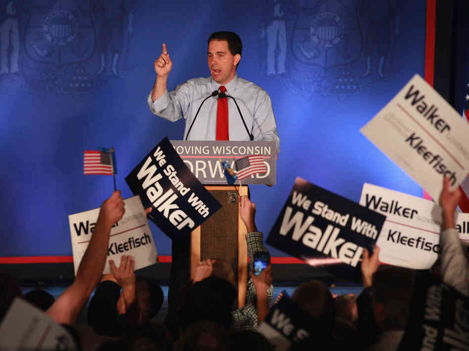 Wisconsin Gov. Scott Walker greets supporters at a rally Tuesday in Waukesha, Wis., after weathering a recall challenge.