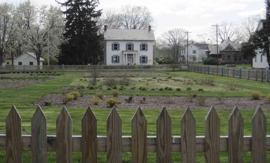This photo provided by the Ohio Historical Society shows a view across the spring garden to the Bimeler Museum in Zoar Village, Ohio. The building which was seriously damaged in an earlier flood is undergoing repairs during this summer. 
