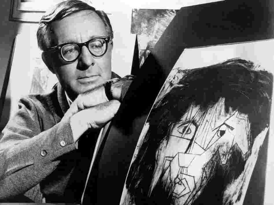 This 1966 file photo shows science fiction writer Ray Bradbury looking at a picture that was part of a school project to illustrate characters in one of his dramas.