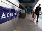 A traveler walks by a Delta Airlines skycap kiosk at San Francisco International Airport. A traveler walks by a Delta Airlines skycap kiosk at San Francisco International Airport.
