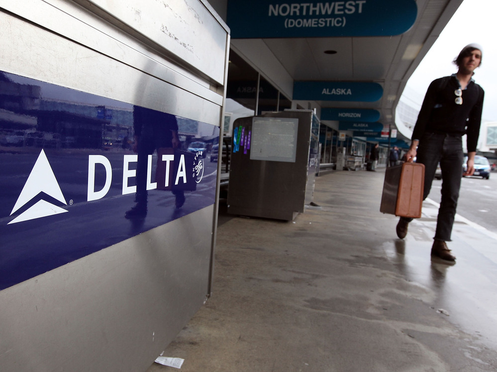 A traveler walks by a Delta Airlines skycap kiosk at San Francisco International Airport.