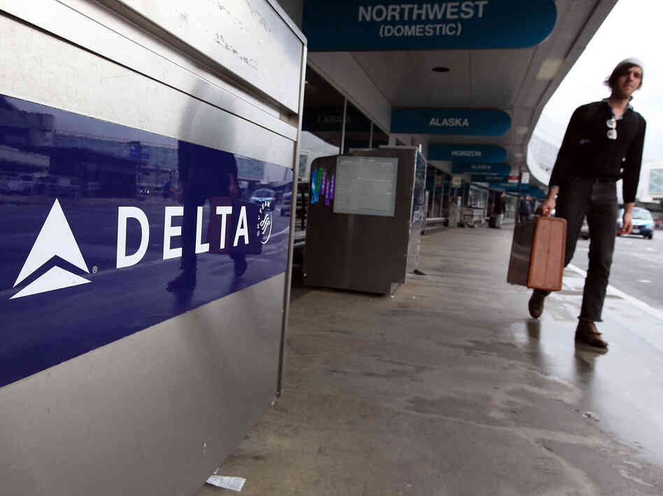 A traveler walks by a Delta Airlines skycap kiosk at San Francisco International Airport.