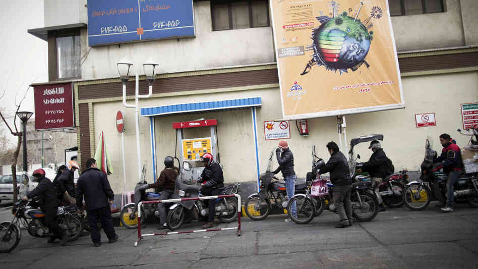 Iranians line up at a gas station to fuel their motorcycles in central Tehran in February. Oil is the lifeblood of Iran's economy, but the planned EU boycott is expected to deal a major blow to Iranian oil exports.