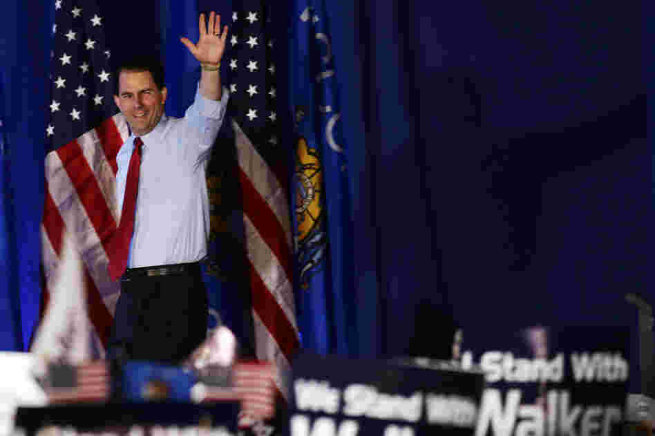 Wisconsin Gov. Scott Walker waves at his victory party Tuesday in Waukesha, Wis. The Republican survived a recall election in the state, defeating his Democratic rival, Tom Barrett.