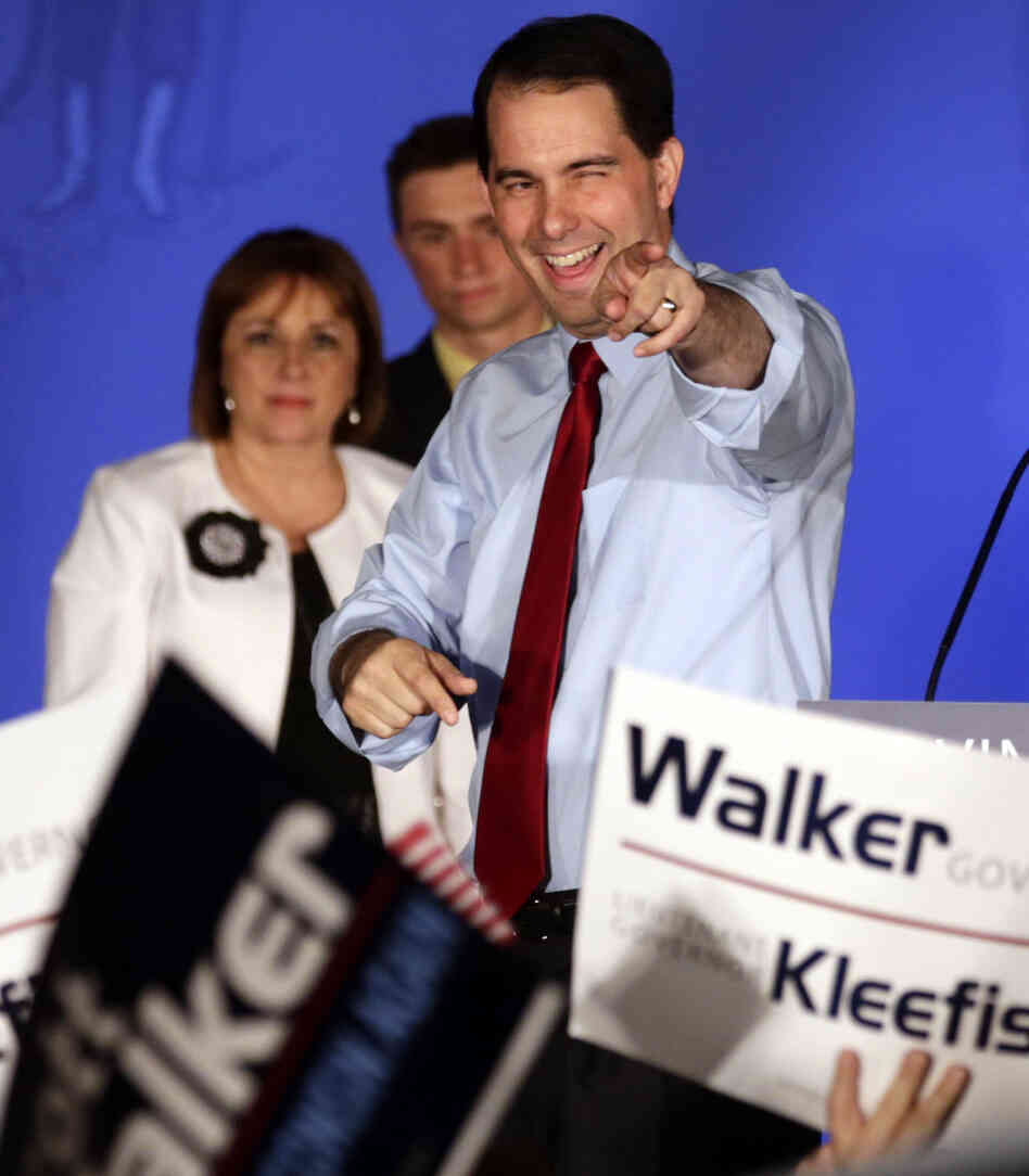 Wisconsin Republican Gov. Scott Walker (right) celebrates his win over Democratic challenger Tom Barrett at Tuesday night's victory party in Waukesha, Wis.