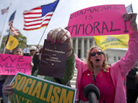 Protesters at the Supreme Court as the court concluded hearing arguments on the health care law. Protesters at the Supreme Court as the court concluded hearing arguments on the health care law.