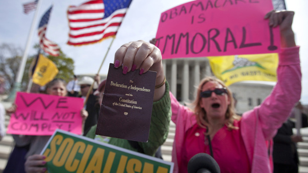 Protesters at the Supreme Court as the court concluded hearing arguments on the health care law.