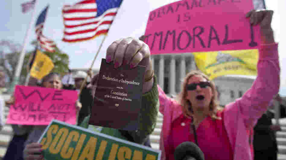 Protesters at the Supreme Court as the court concluded hearing arguments on the health care law.