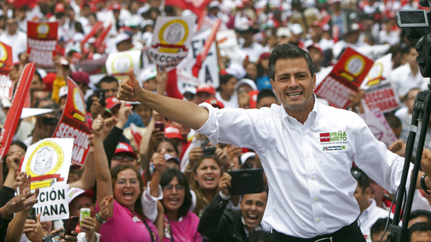 Mexican presidential front-runner Enrique Pena Nieto of the Institutional Revolutionary Party, or PRI, waves to the crowds during a campaign stop in the northern border city of Tijuana, Mexico, on June 3. The once dominant PRI, out of power for the past 12 years, looks likely to make a comeback.