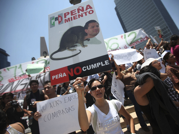 A demonstrator holds an anti-Pena Nieto sign during a May 19 protest against the PRI candidate in Mexico City.