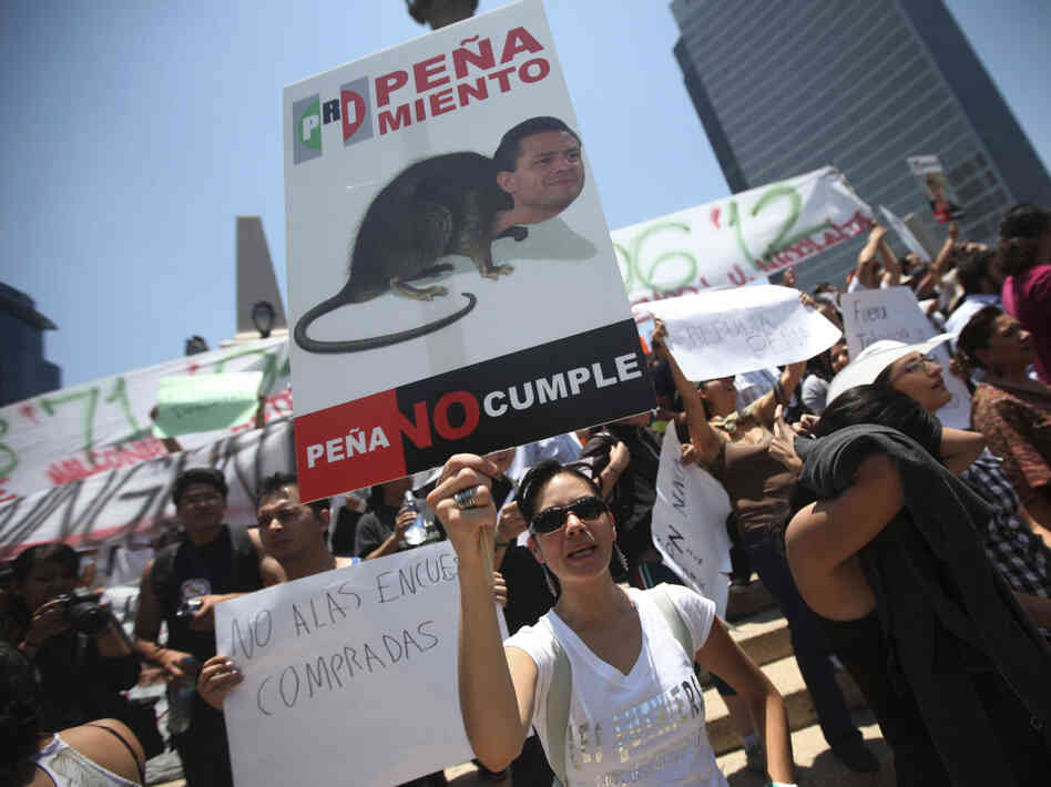 A demonstrator holds an anti-Pena Nieto sign during a May 19 protest against the PRI candidate in Mexico City.
