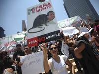 A demonstrator holds an anti-Pena Nieto sign during a May 19 protest against the PRI candidate in Mexico City.