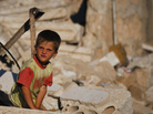 A Syrian boy sits in the rubble of house which was destroyed during a military operation by the Syrian pro-Assad army in April in the town of Taftanaz, Syria. A Syrian boy sits in the rubble of house which was destroyed during a military operation by the Syrian pro-Assad army in April in the town of Taftanaz, Syria.
