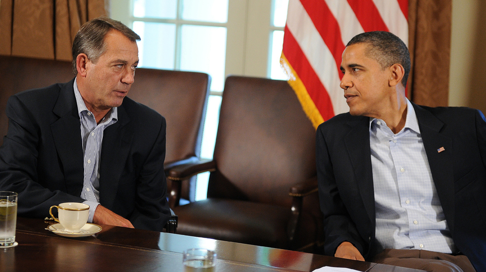 President Obama speaks with House Speaker John Boehner during a meeting at the White House in 2011. A slowdown in job growth and a looming tax deadline could force the president to try to revive his "grand bargain" with Republicans.