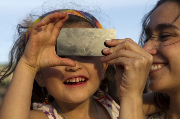 A "little scientist" watches the transit of Venus across the face of the sun on June 5, 2012, in Medellin, Colombia.