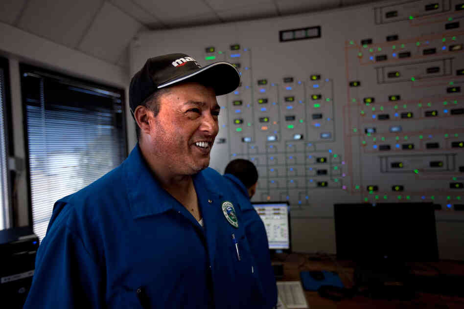 Abujala Zenati in the central control room at the oil production facility at Al-Sidrah. 