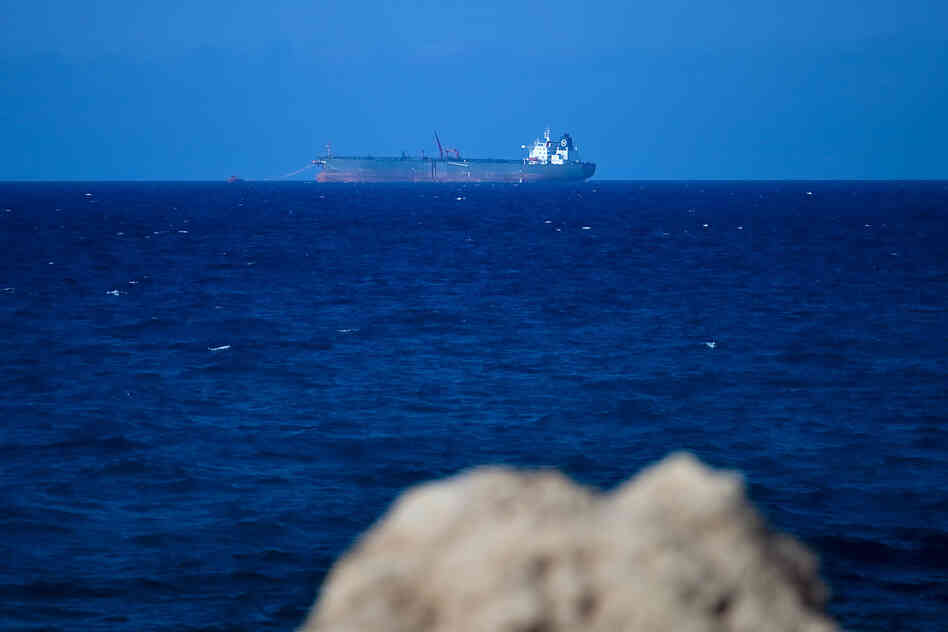 An oil tanker sits off the coast of Al-Sidra, filling its tanks with oil from an undersea pipeline. Oil production crashed during last year's fighting, but is now approaching pre-revolutionary levels.