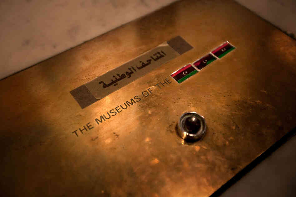 A display in Libya's national museum used to read "The Museums of the Jamahiriya." Jamihiriya was a word Ghaddfi invented to describe the governing system of Libya. The word has been covered with stickers of the revolutionary flag.