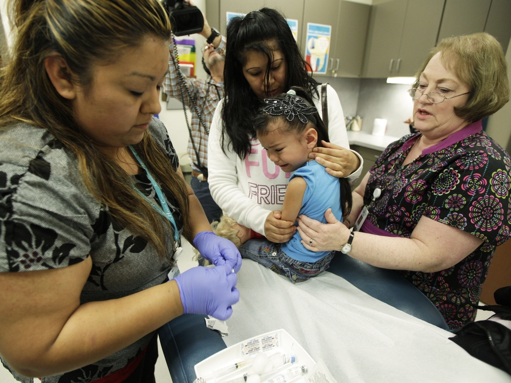 A nurse in Washington administers the whooping cough vaccine to a child in May. In response to the epidemic, more than 82,000 adults have also received the vaccine this year.