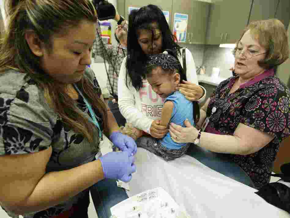 A nurse in Washington administers the whooping cough vaccine to a child in May. In response to the epidemic, more than 82,000 adults have also received the vaccine this year.
