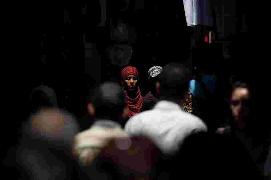 People walk through the narrow streets of Tunis' medina, or marketplace.