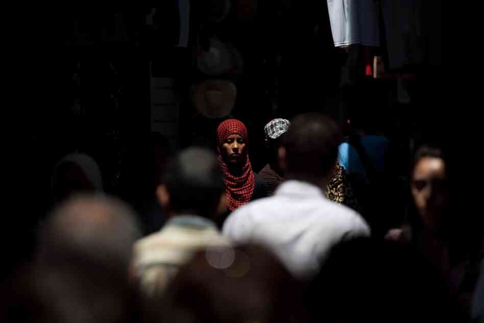 People walk through the narrow streets of Tunis' medina, or marketplace.
