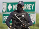A Mexican federal policeman guards the area where dozens of bodies, some of them mutilated, were found on a highway outside the northern Mexican city of Monterrey on May 13. The murders were one of the latest episodes in Mexico's brutal and unrelenting drug war. A Mexican federal policeman guards the area where dozens of bodies, some of them mutilated, were found on a highway outside the northern Mexican city of Monterrey on May 13. The murders were one of the latest episodes in Mexico's brutal and unrelenting drug war.