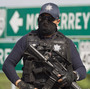 A Mexican federal policeman guards the area where dozens of bodies, some of them mutilated, were found on a highway outside the northern Mexican city of Monterrey on  May 13. The murders were one of the latest episodes in Mexico's brutal and unrelenting drug war.