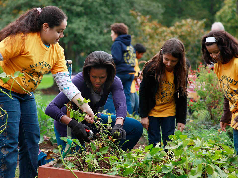 First Lady Michelle Obama, here with students from Bancroft Elementary School and Kimball Elementary School,  has done a lot to promote healthy family dinners and garden-fresh food.