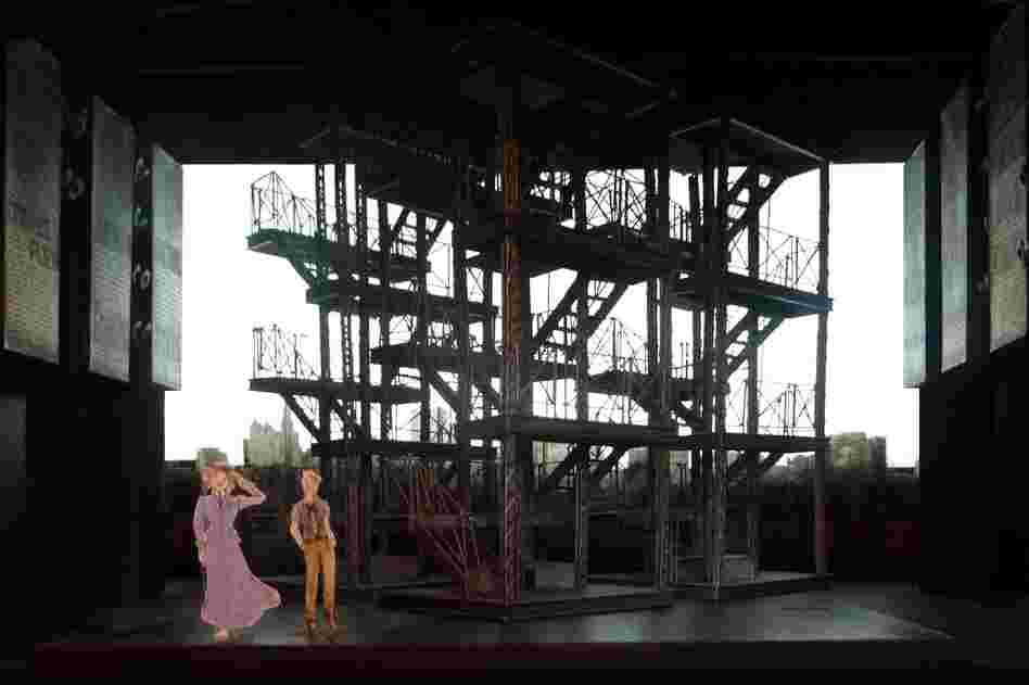 The mobile metal scaffoldings in Ost's design stand in for the cityscape and also support screens for the production's video projections.