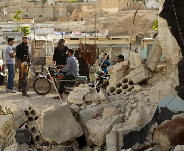 Late last month, people gathered near a home that had been destroyed by fighting in al-Latamneh, Hama Province, Syria.