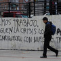 Graffiti on a wall in Madrid reads, "We want to work, let the businessmen who have gotten rich from our labor pay for the crisis." Nearly 50 percent of young adults in Spain are unemployed. Graffiti on a wall in Madrid reads, "We want to work, let the businessmen who have gotten rich from our labor pay for the crisis." Nearly 50 percent of young adults in Spain are unemployed.