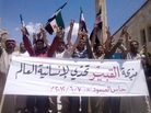 Anti-government protesters in the northern Syrian village of Hass protest on Thursday following the deaths of dozens of civilians a day earlier in the village of Mazraat al-Qubair. The banner reads, "The al-Qubair massacre challenges the world's humanity." Anti-government protesters in the northern Syrian village of Hass protest on Thursday following the deaths of dozens of civilians a day earlier in the village of Mazraat al-Qubair. The banner reads, "The al-Qubair massacre challenges the world's humanity."