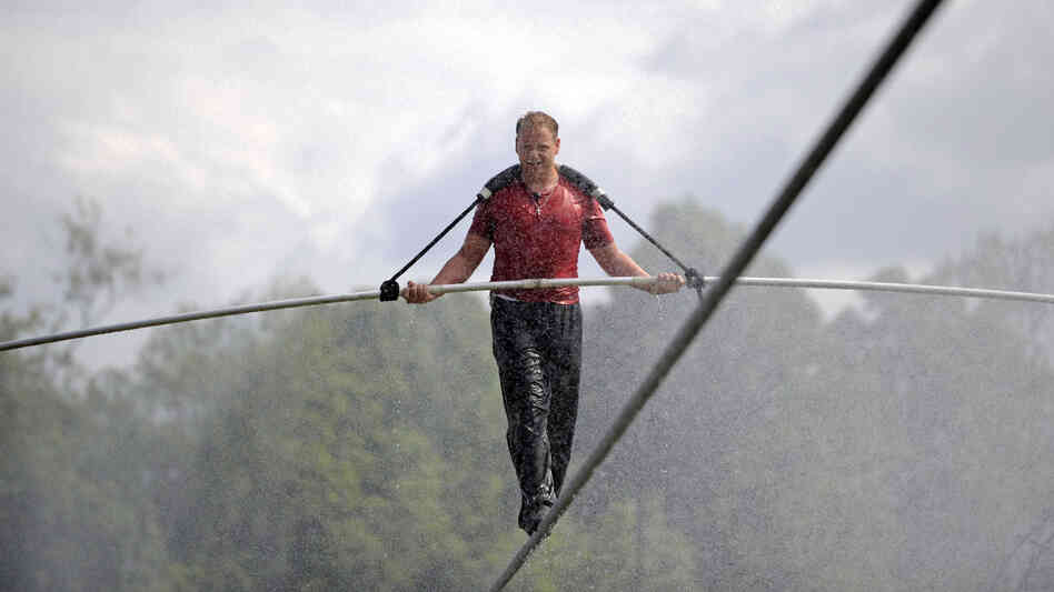 Nik Wallenda walks a tightrope in the rain during a training session for his upcoming stunt in Niagara Falls, N.Y.