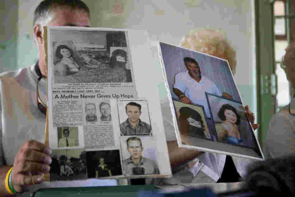 Dave Widner holds up an article about his uncles, inmates John Anglin and Clarence Anglin.