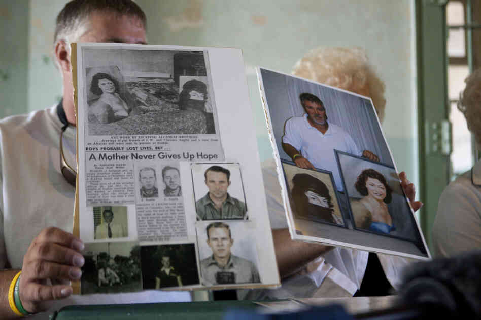 Dave Widner holds up an article about his uncles, inmates John Anglin and Clarence Anglin.