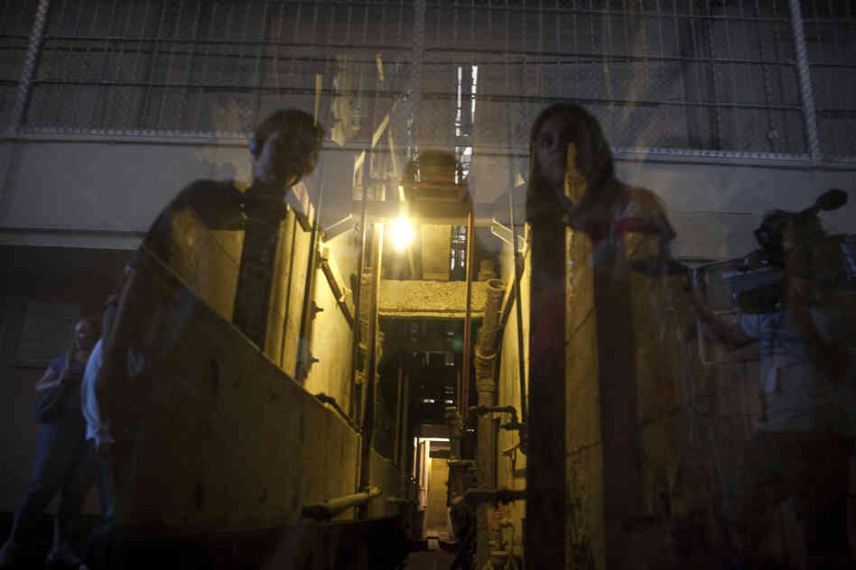Visitors to Alcatraz look down the hall that the inmates used to escape from their cells.