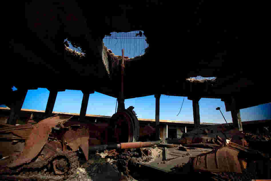 A destroyed building in Misrata holds the damaged remains of tanks that belonged to Moammar Gadhafi's forces. 