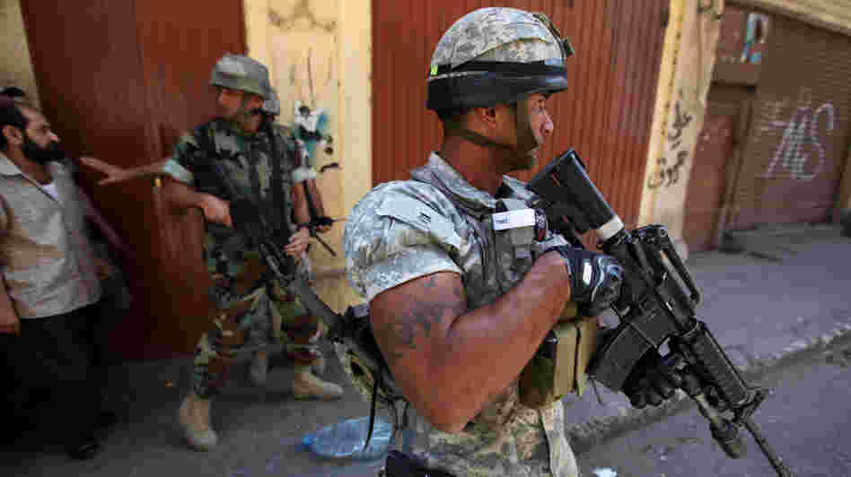 Syria's turmoil has been spreading into Lebanon, where residents say Syrian soldiers have crossed the border and killed civilians. Here, Lebanese army soldiers patrol in the northern port city of Tripoli, Lebanon, earlier this month, where clashes broke out between pro- and anti-Syria gunmen.