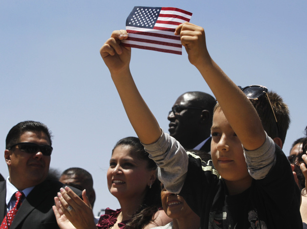 Audience members listen to President Obama speak about immigration reform in El Paso, Texas, in May 2011. The Obama campaign is wooing Hispanics ahead of the November elections, but the president's deportation policy is being criticized by immigrant advocates.