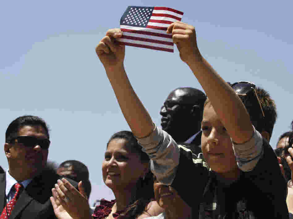 Audience members listen to President Obama speak about immigration reform in El Paso, Texas, in May 2011. The Obama campaign is wooing Hispanics ahead of the November elections, but the president's deportation policy is being criticized by immigrant advocates.