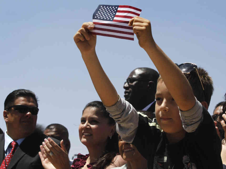 Audience members listen to President Obama speak about immigration reform in El Paso, Texas, in May 2011. The Obama campaign is wooing Hispanics ahead of the November elections, but the president's deportation policy is being criticized by immigrant advocates.